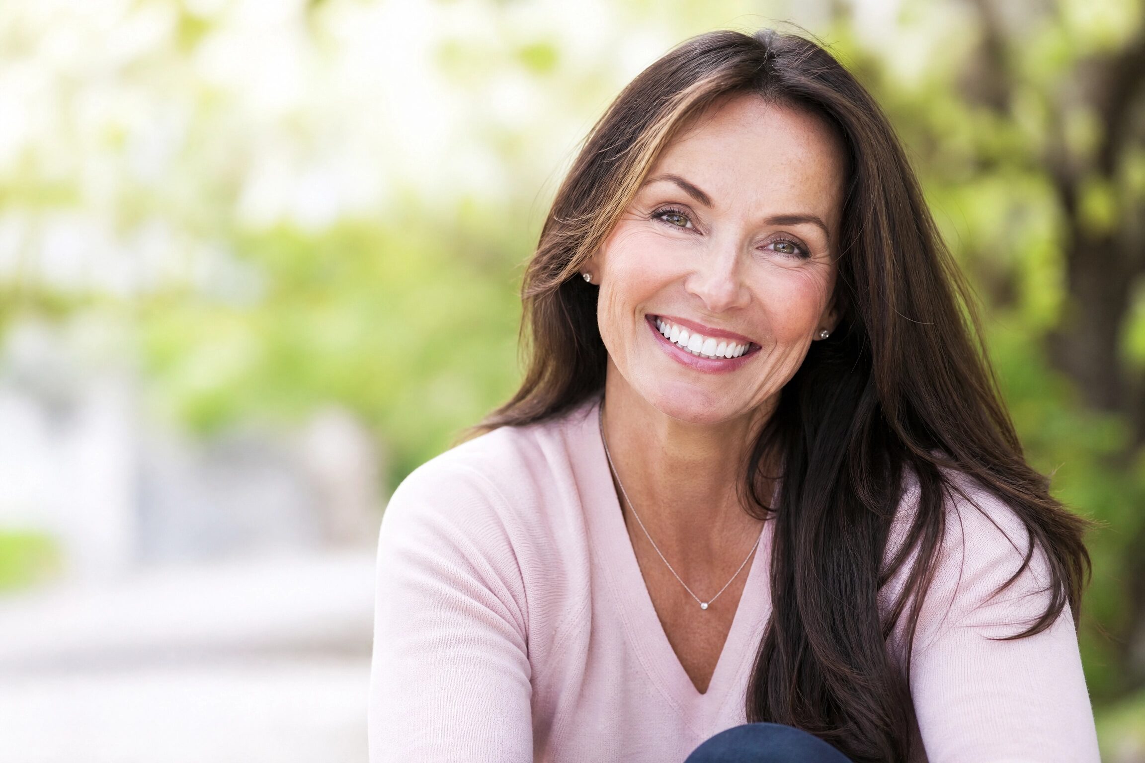 Confident woman smiling after Invisalign treatment - improved oral health and systemic wellbeing at Anderson Smile Center Cincinnati
