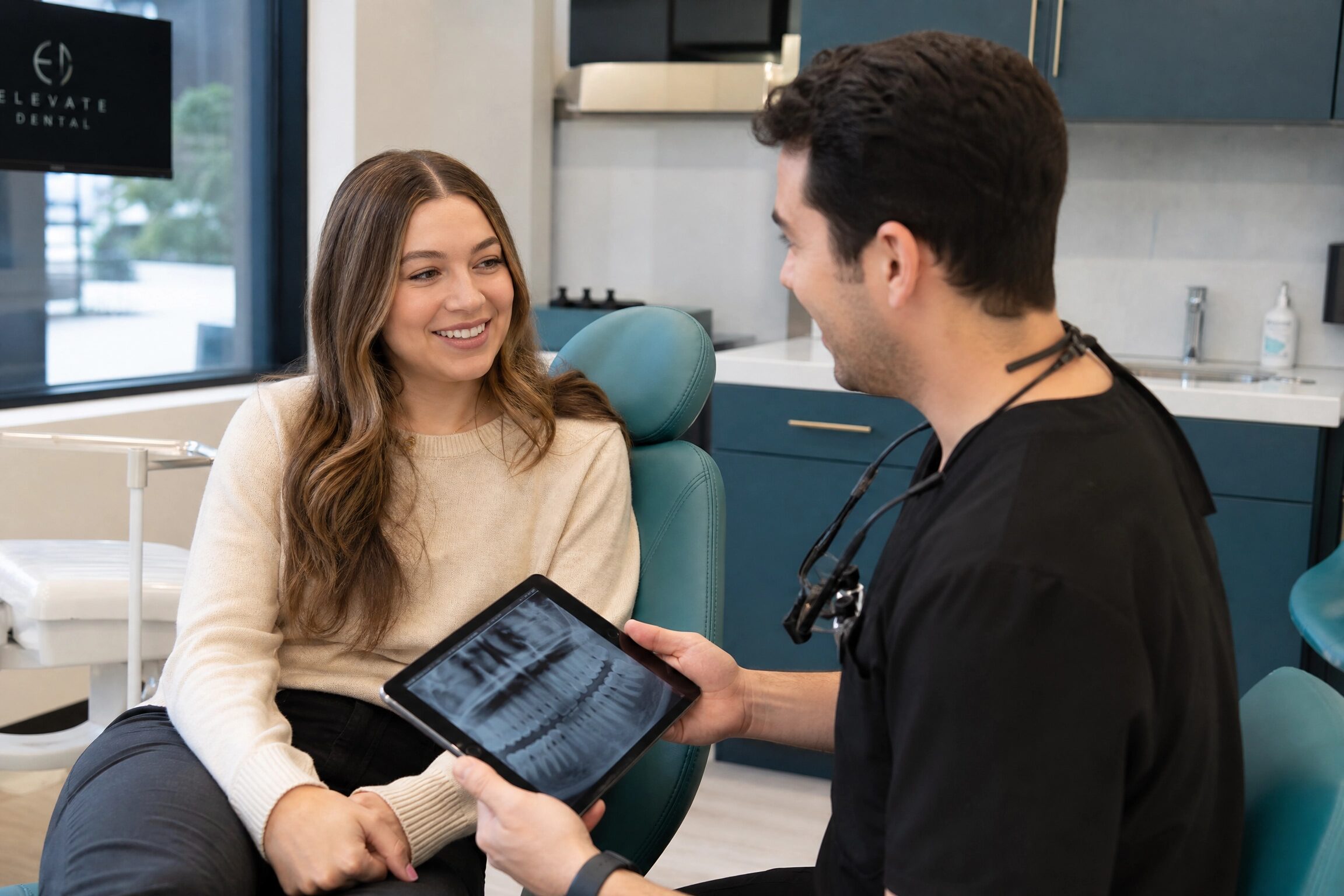 Dentist reviewing wisdom teeth X-ray with patient at Anderson Smile Center Cincinnati